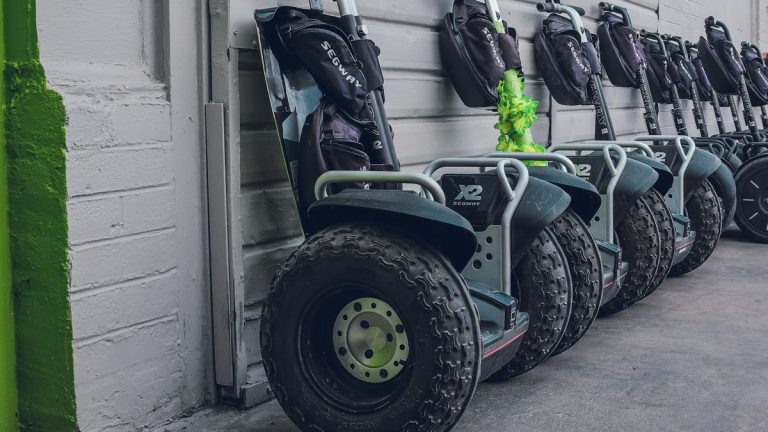 Self-balancing scooters parked beside a wall