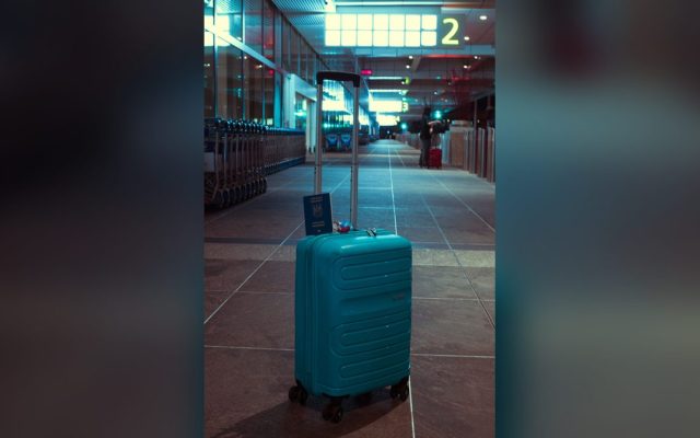 Suitcase with a passport in an airport terminal