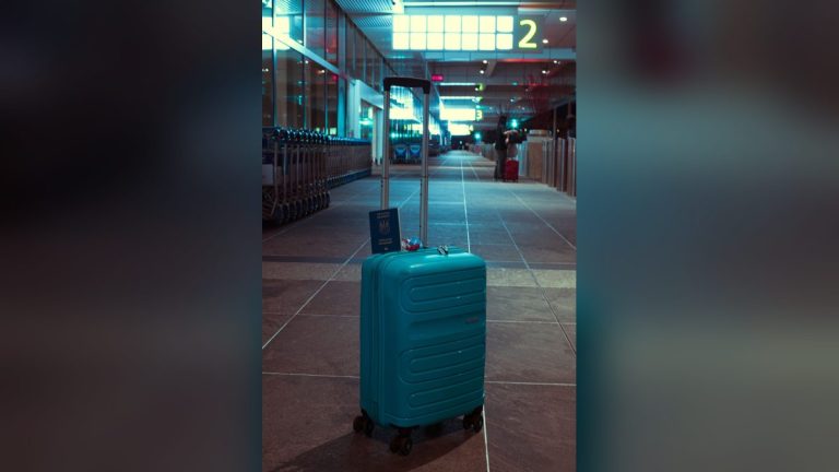 Suitcase with a passport in an airport terminal