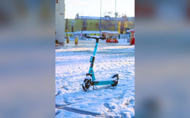 Teal electric scooter on a snowy street