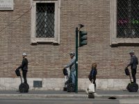 Three people riding hoverboards