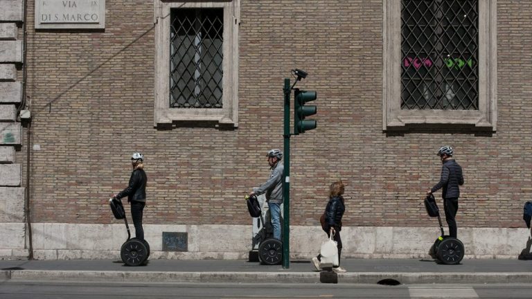 Three people riding hoverboards
