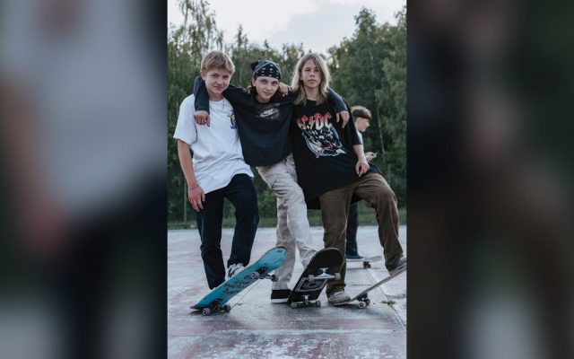 Three teenage skateboarders in a park
