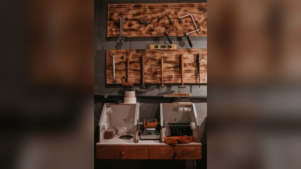 Tools arranged on a wooden pegboard