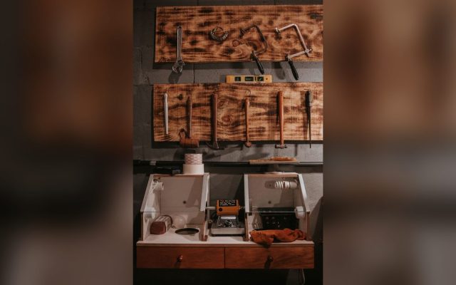 Tools arranged on a wooden pegboard