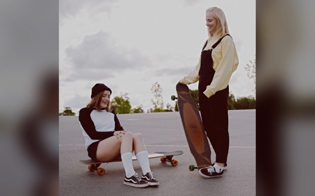 Two friends enjoying a longboarding day