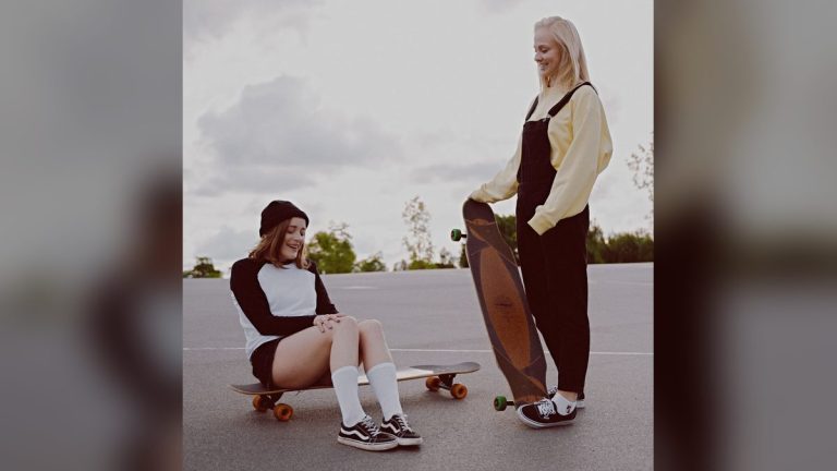 Two friends enjoying a longboarding day