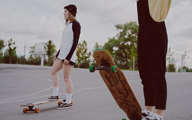 Two young women with longboards