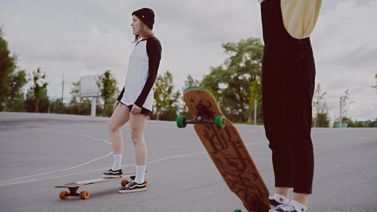 Two young women with longboards
