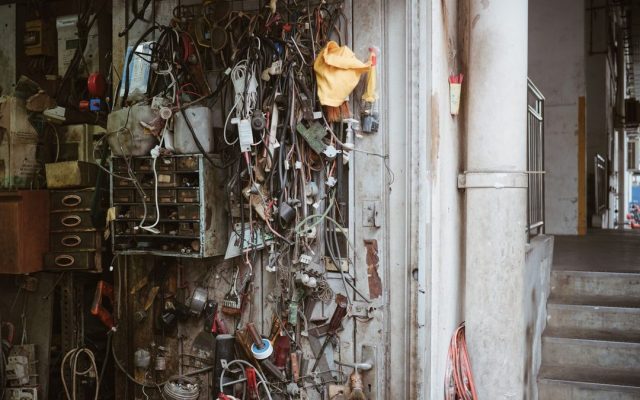 Wires, tools and gadgets on a workshop wall