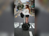 Woman riding a self-balancing scooter downtown