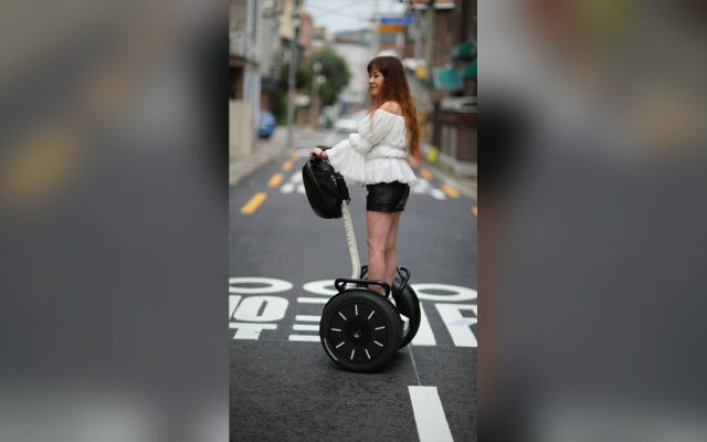 Woman riding a self-balancing scooter downtown