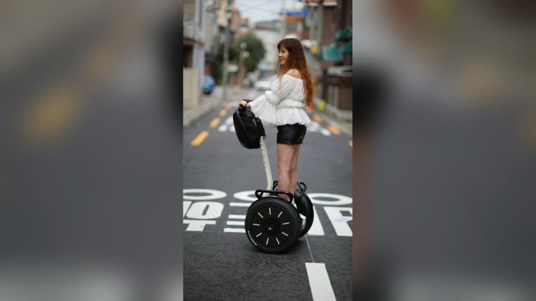 Woman riding a self-balancing scooter downtown