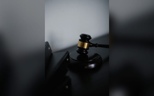 Wooden gavel on a table near folders