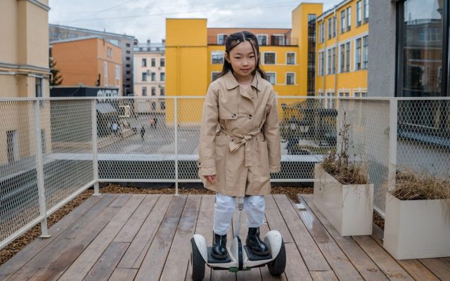 Young girl riding a hoverboard on a deck