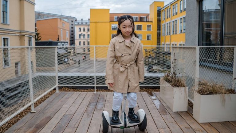 Young girl riding a hoverboard on a deck