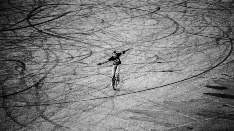 Young man performing freestyle unicycle tricks