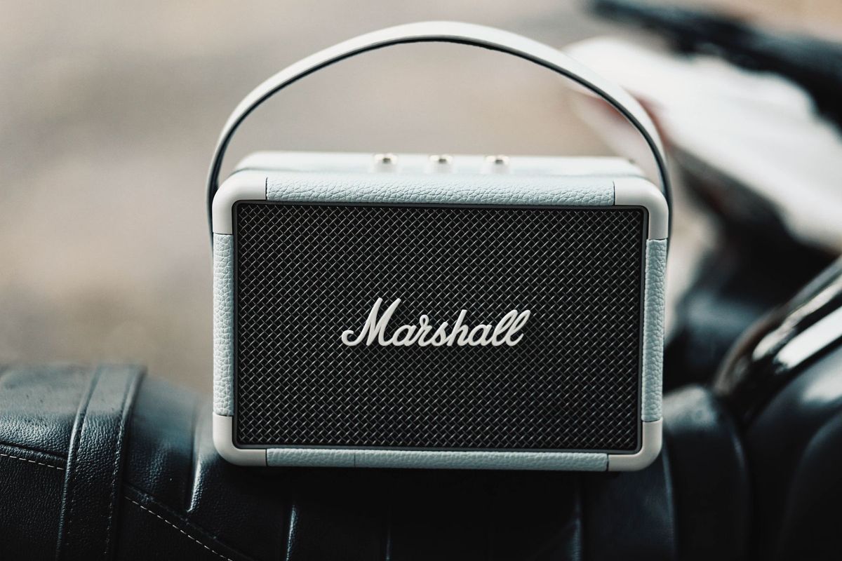 A sleek, portable Marshall wireless speaker with a leather finish
