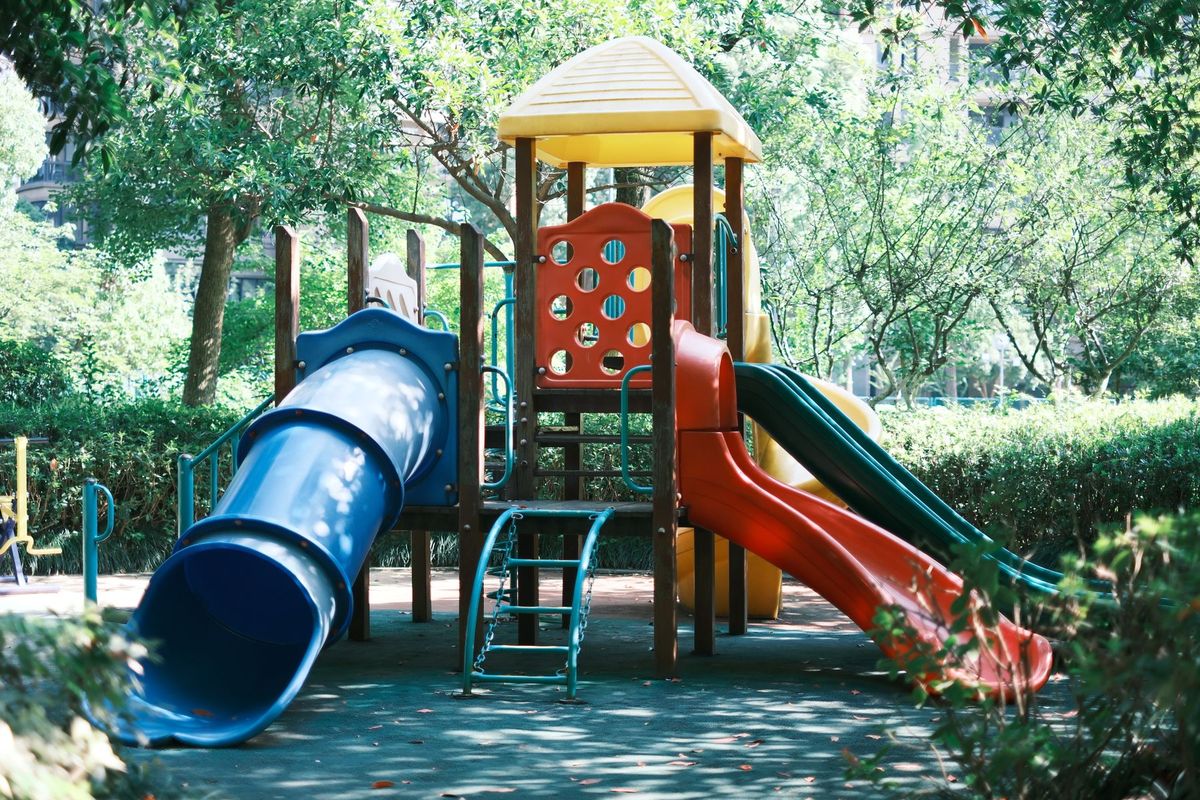 A vibrant playground slide set in a sunny park