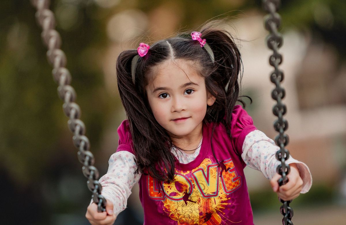 A young girl enjoying a swing ride in a Canadian park