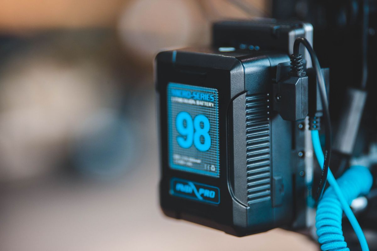 Close-up of a high-capacity portable battery with digital display showing 98 percent charge