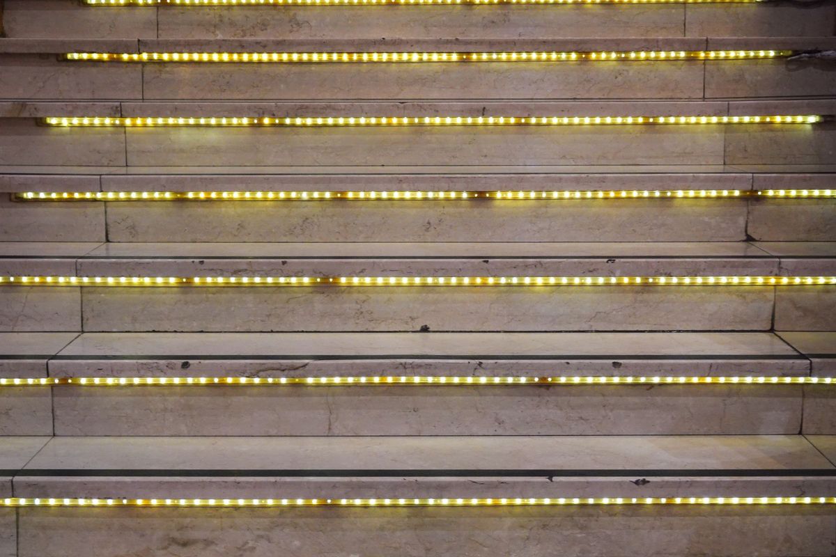 Close-up of a staircase with glowing LED lights on each step
