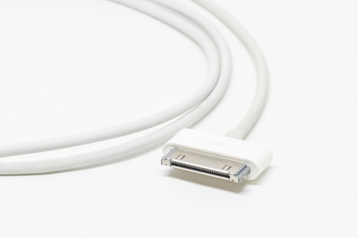 Close-up of a white USB charging cable on a white background