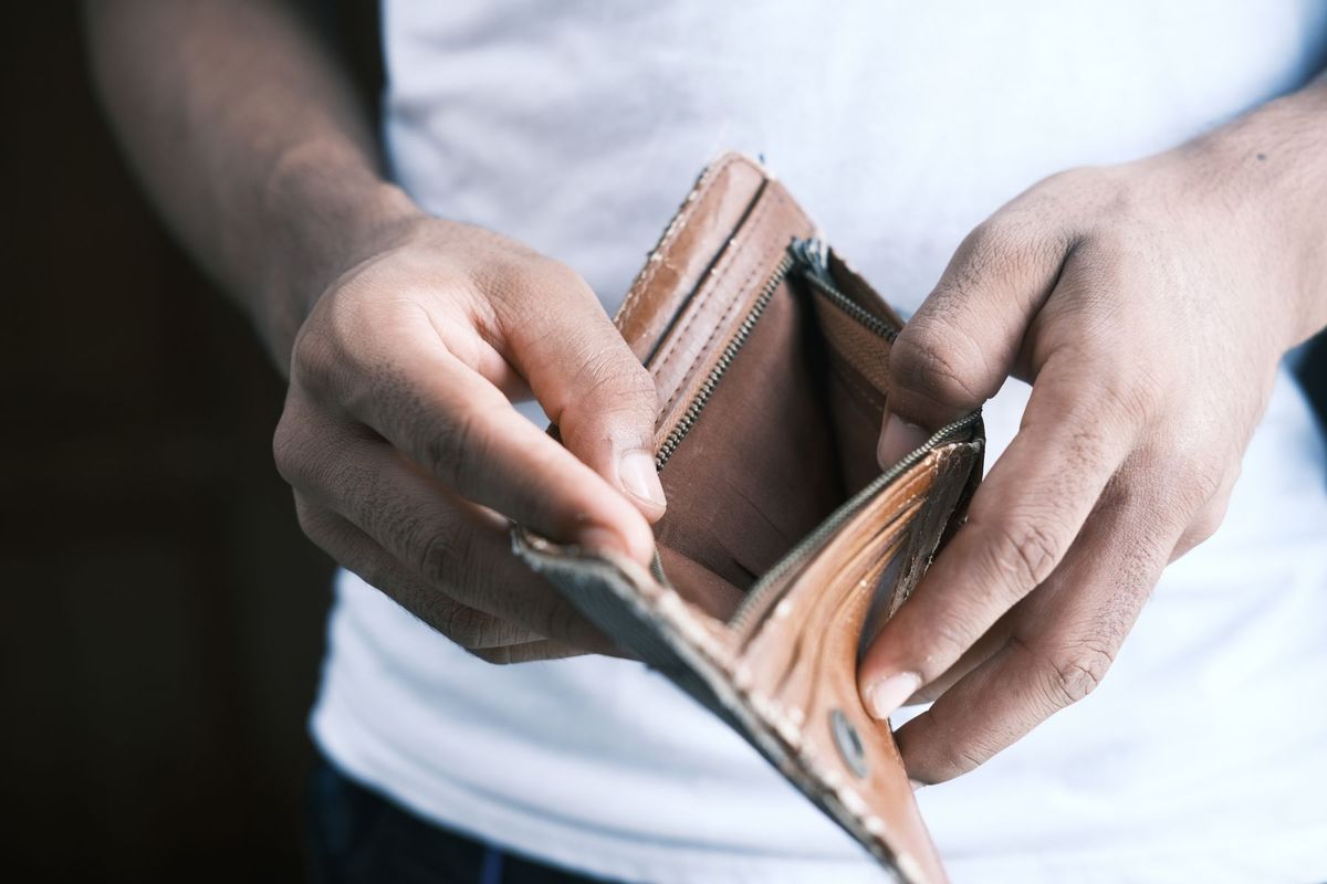 Close-up of hands holding an empty wallet