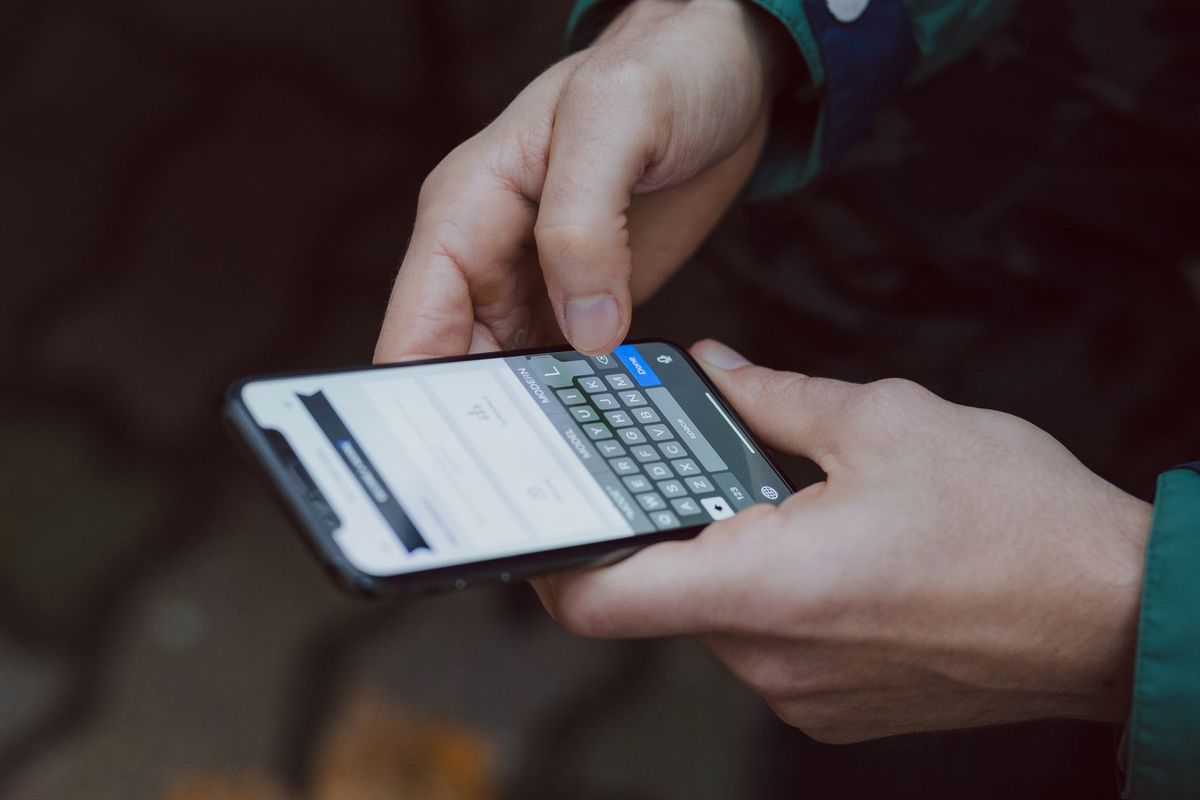Close-up of person texting on a smartphone. Outdoor setting with wireless connectivity