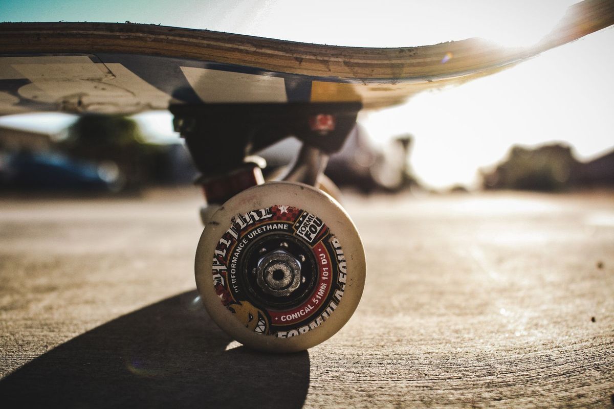 Detailed shot of a skateboard wheel on concrete outdoors. High-quality focus and lighting
