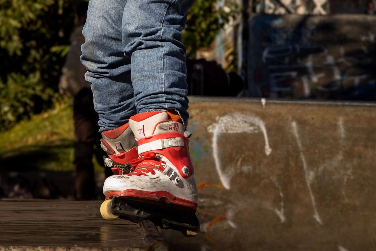Dynamic shot of inline skates in action at an urban skate park