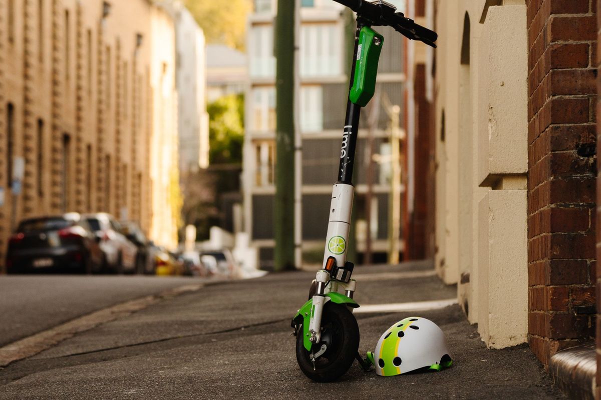 Electric scooter with helmet on a sidewalk in Teneriffe, Australia