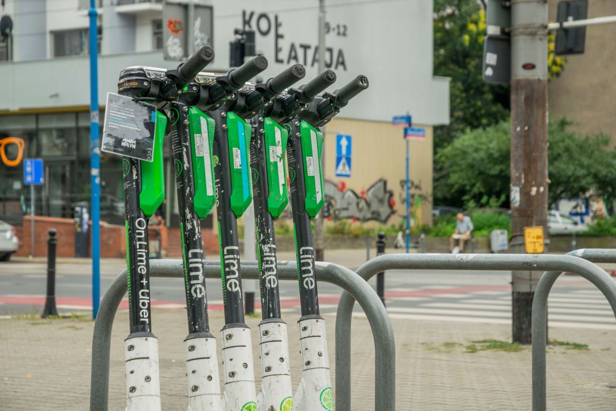 Electric scooters lined up on a street in Wrocław, Poland