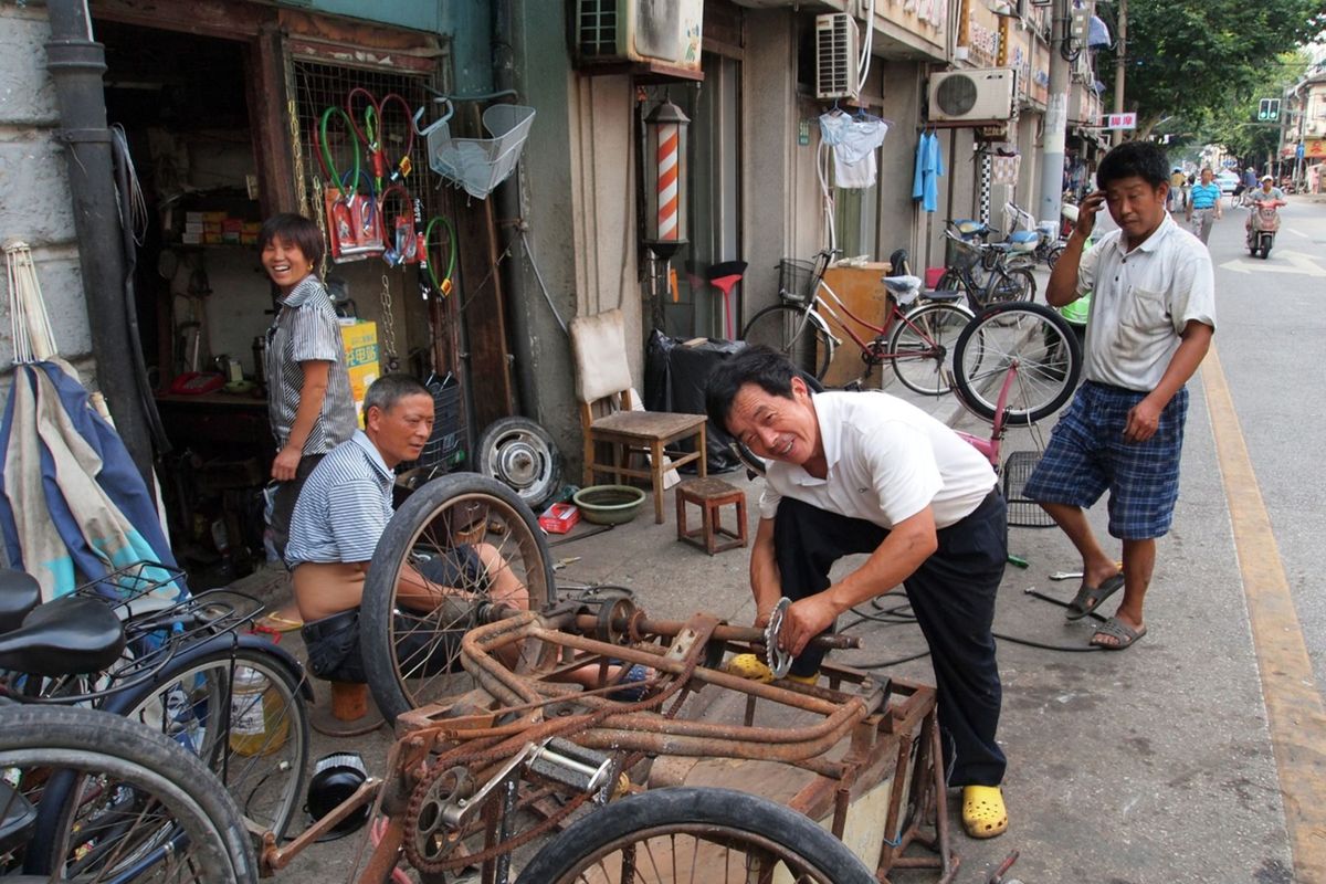 Local bicycle repair in Shanghai's bustling street