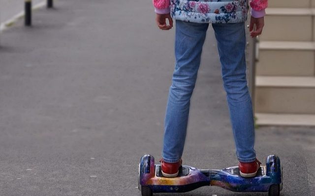 Rider standing on a hoverboard with lit wheels