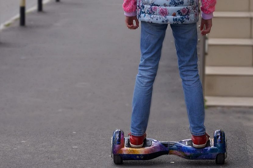 Rider standing on a hoverboard with lit wheels